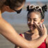 woman-applying-sunscreen-kid-front-view