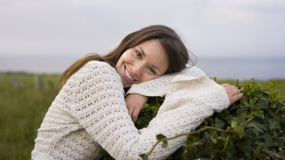 medium-shot-smiley-woman-posing-outside